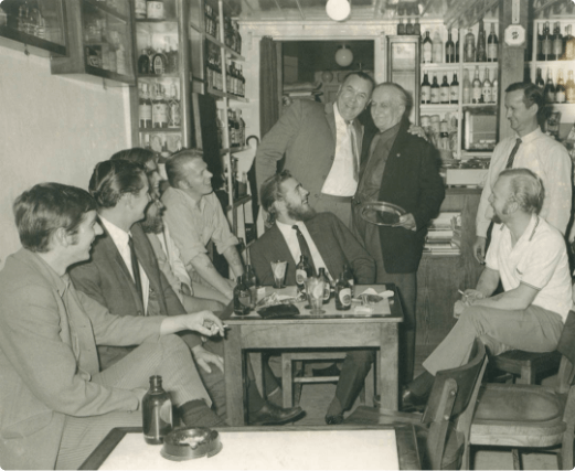  Old photograph of the interior of Peter Cafe Sport with the owner and some members of the ship H.M.S. Lusitania II of the Royal Navy. 